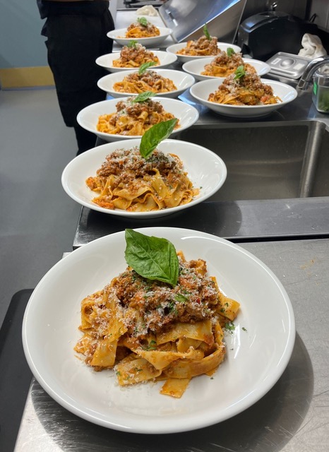 Pappardelle bolognese plated at La Costa
